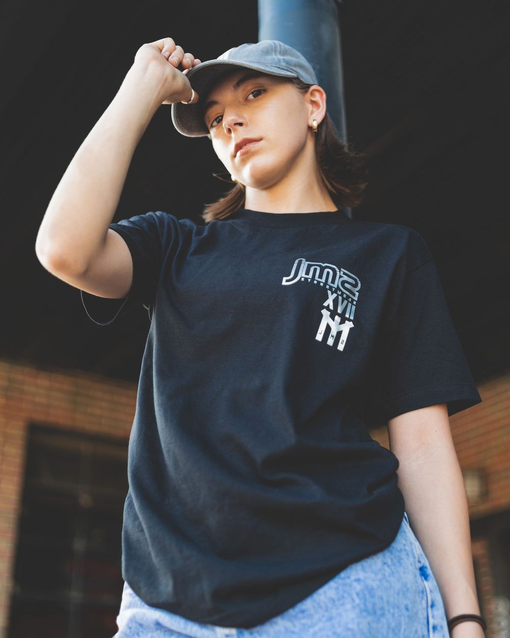 Photo of teenage female wearing JMS Streetwear t-shirt.  Photo by Brian Balloon