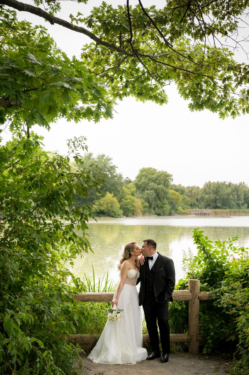 Romantic moment of a bride and groom hand in hand at their Toronto wedding.