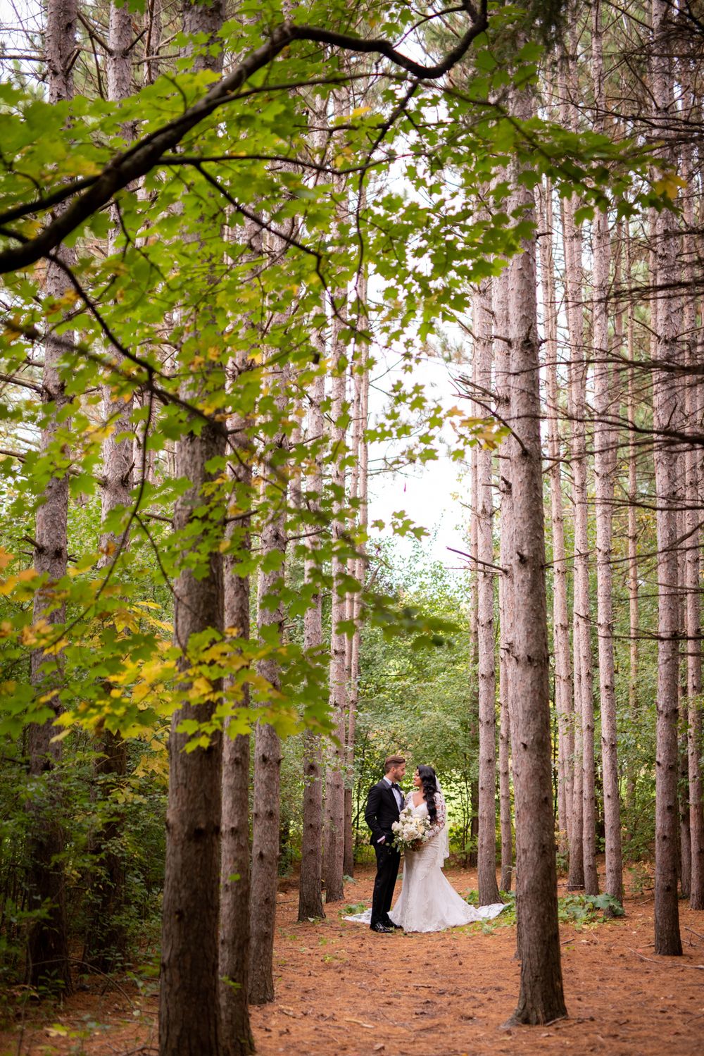 Fall wedding portrait of a couple outdoors, photographed with natural light and vivid colors.