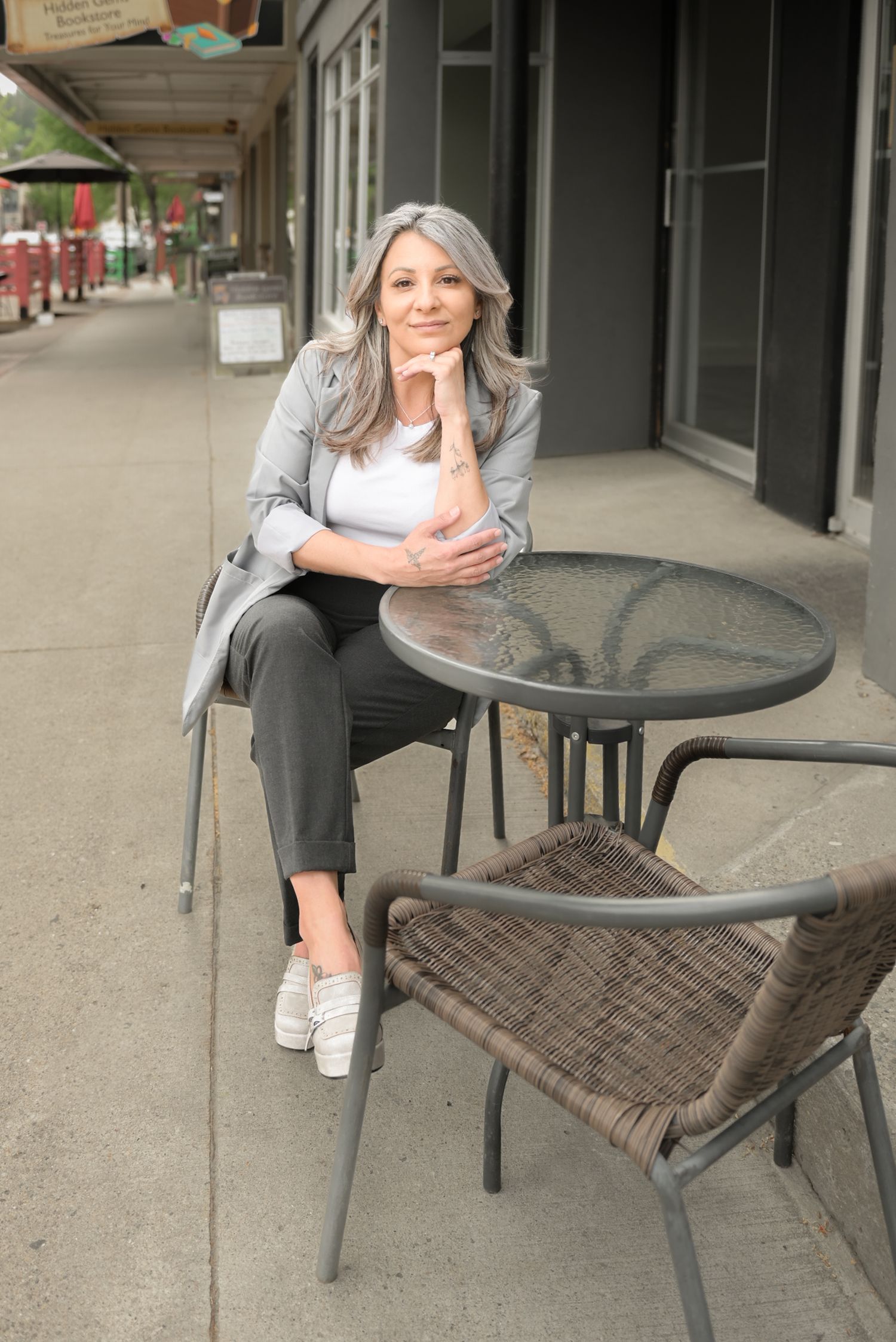 Outdoor cafe scene with metal furniture showing casual seated poses.