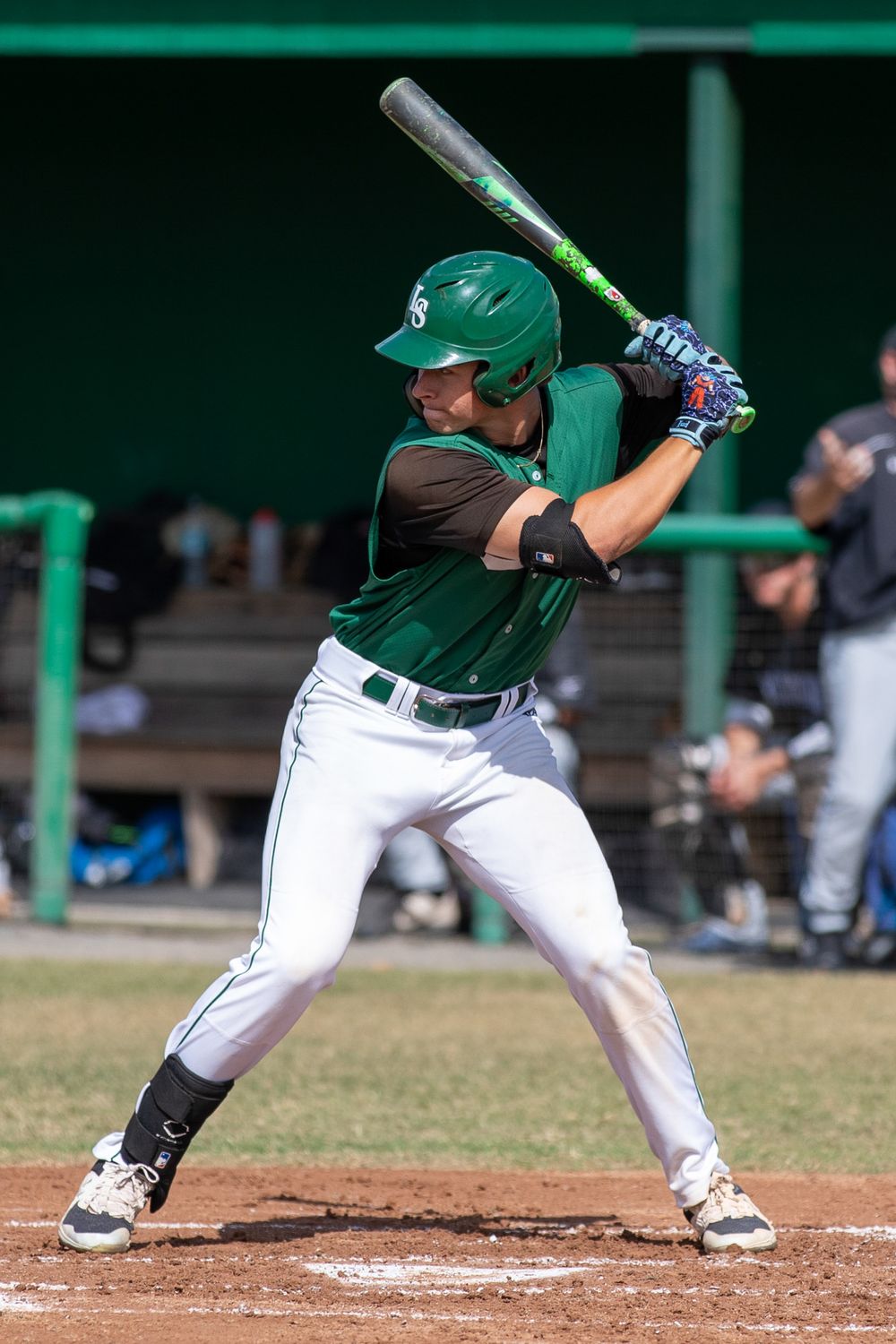 Baseball batting sequence showing proper stance and swing form in green uniforms.
