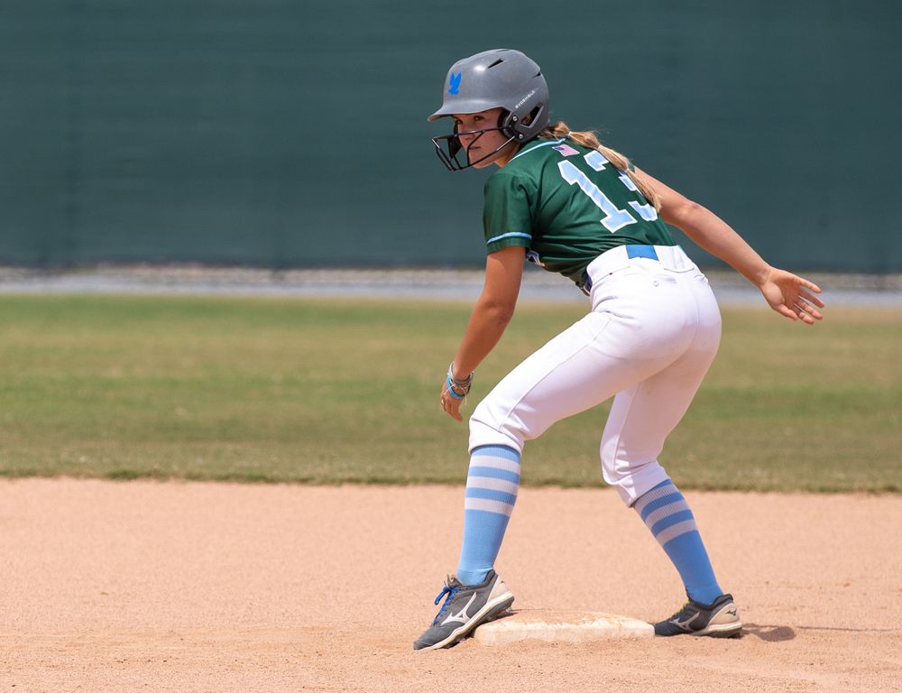 Baseball players in fielding positions on baseball diamond during game.