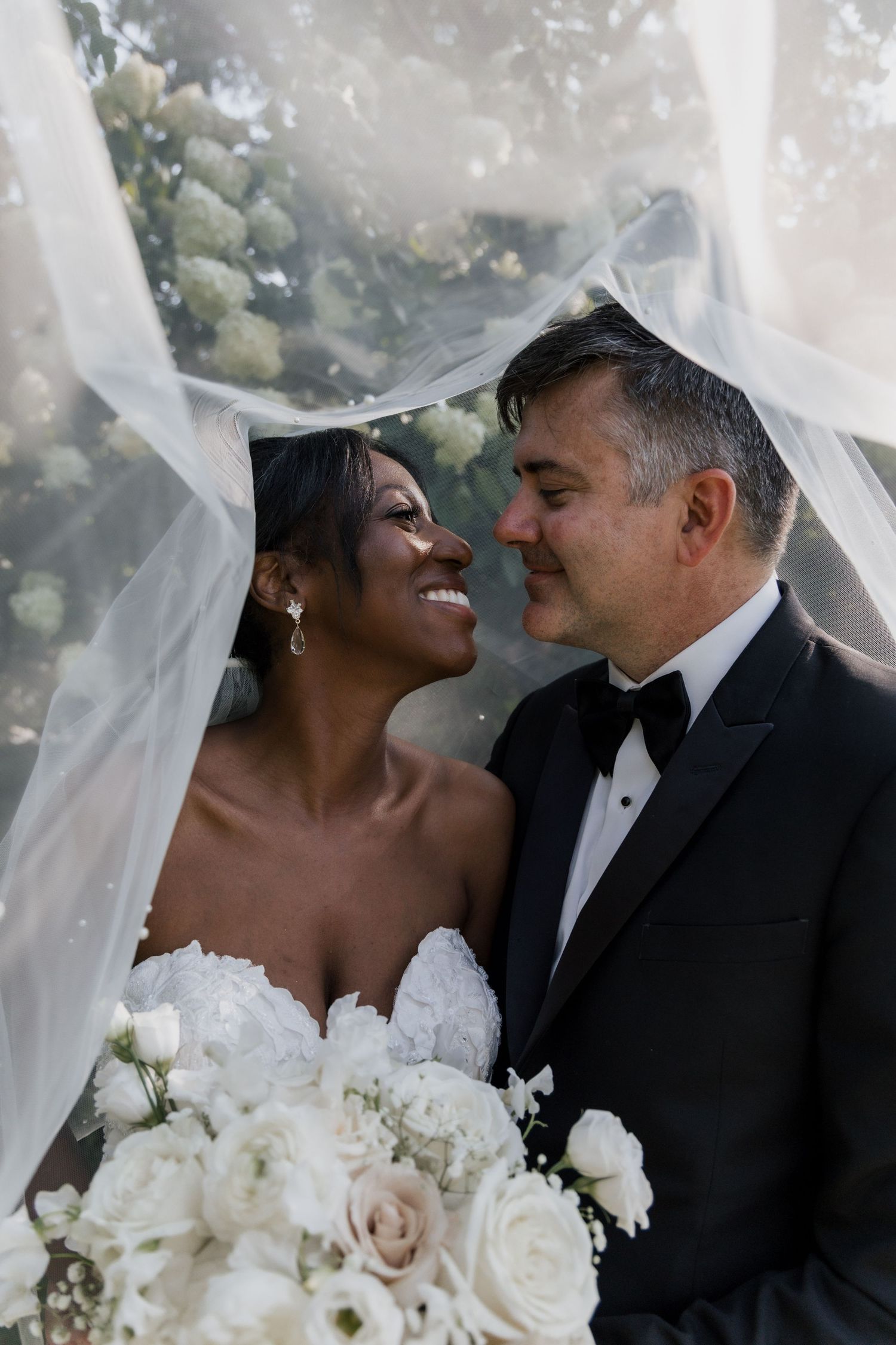 bride and groom veil shot