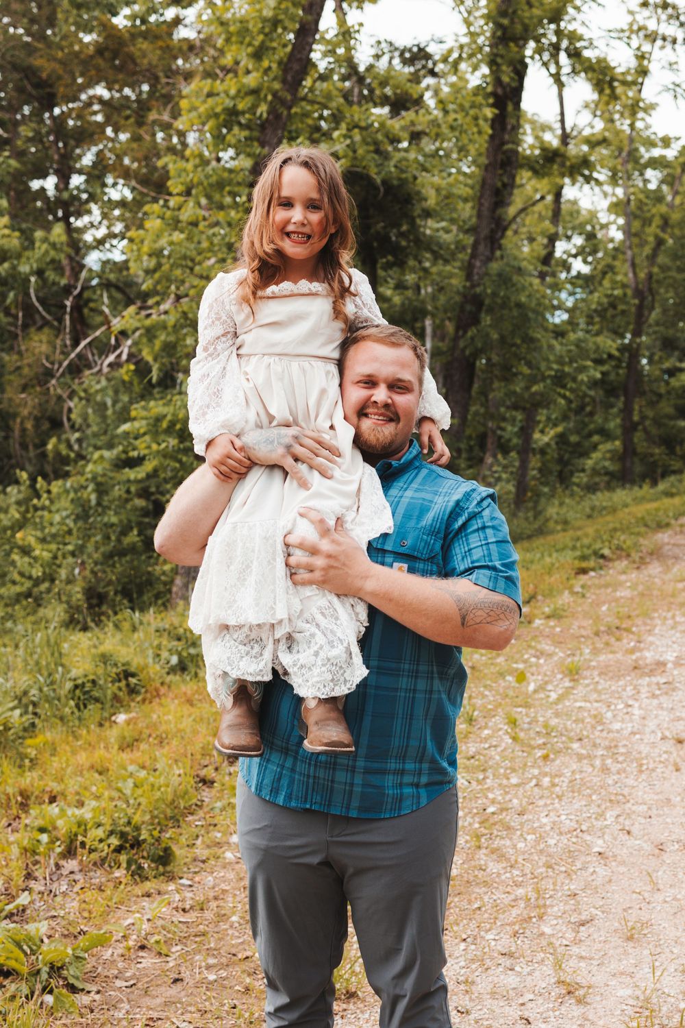 A sweet outdoor portrait of parent and child enjoying quality time on a forested trail.