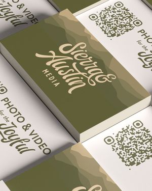 Stacks of modern business cards with QR codes and green branding elements arranged in a diagonal pattern.