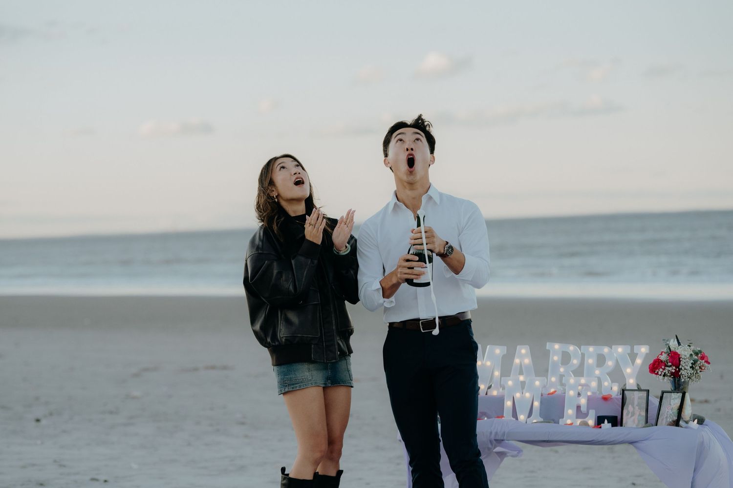Eric and Emily popping champagne