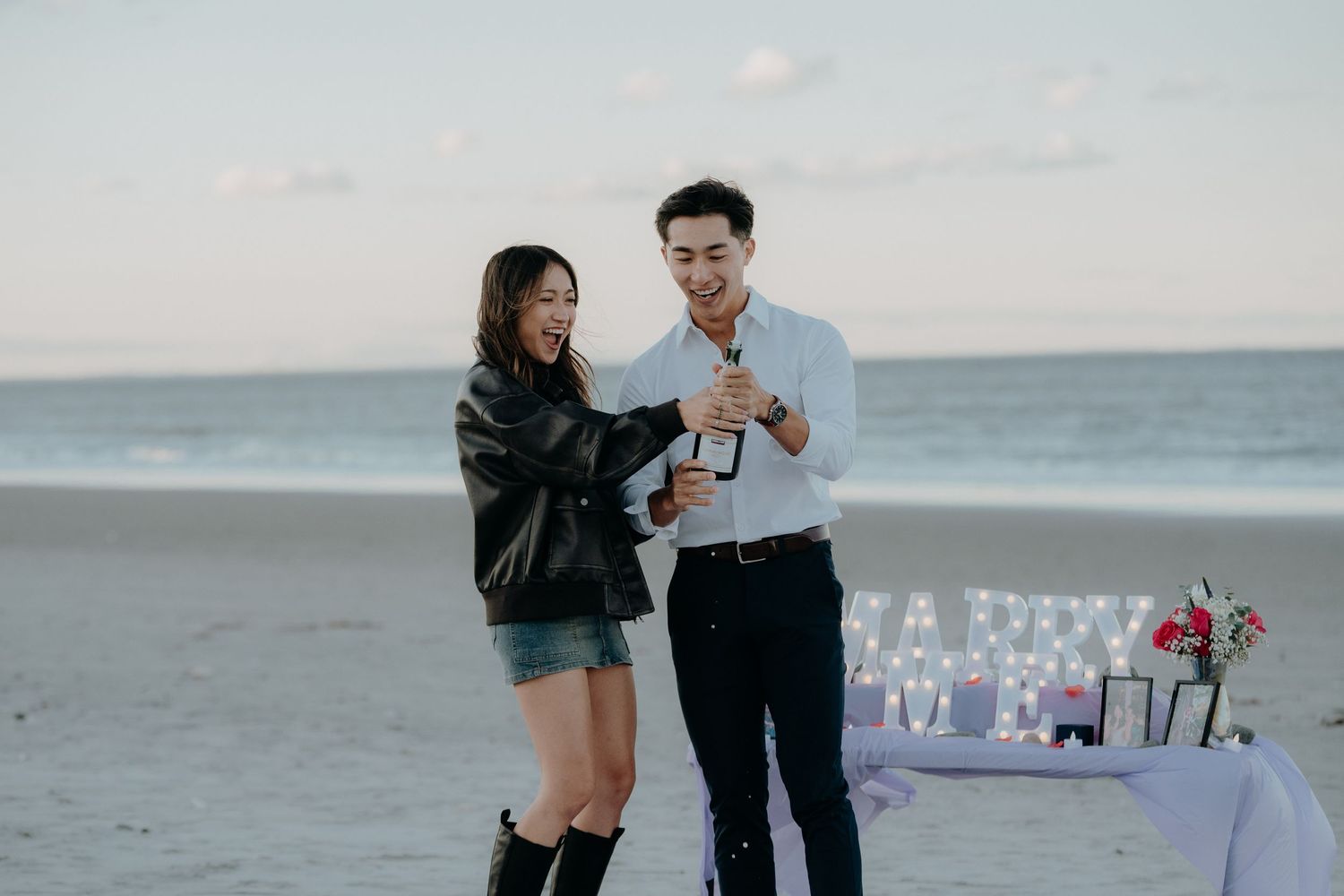 Eric and Emily popping champagne