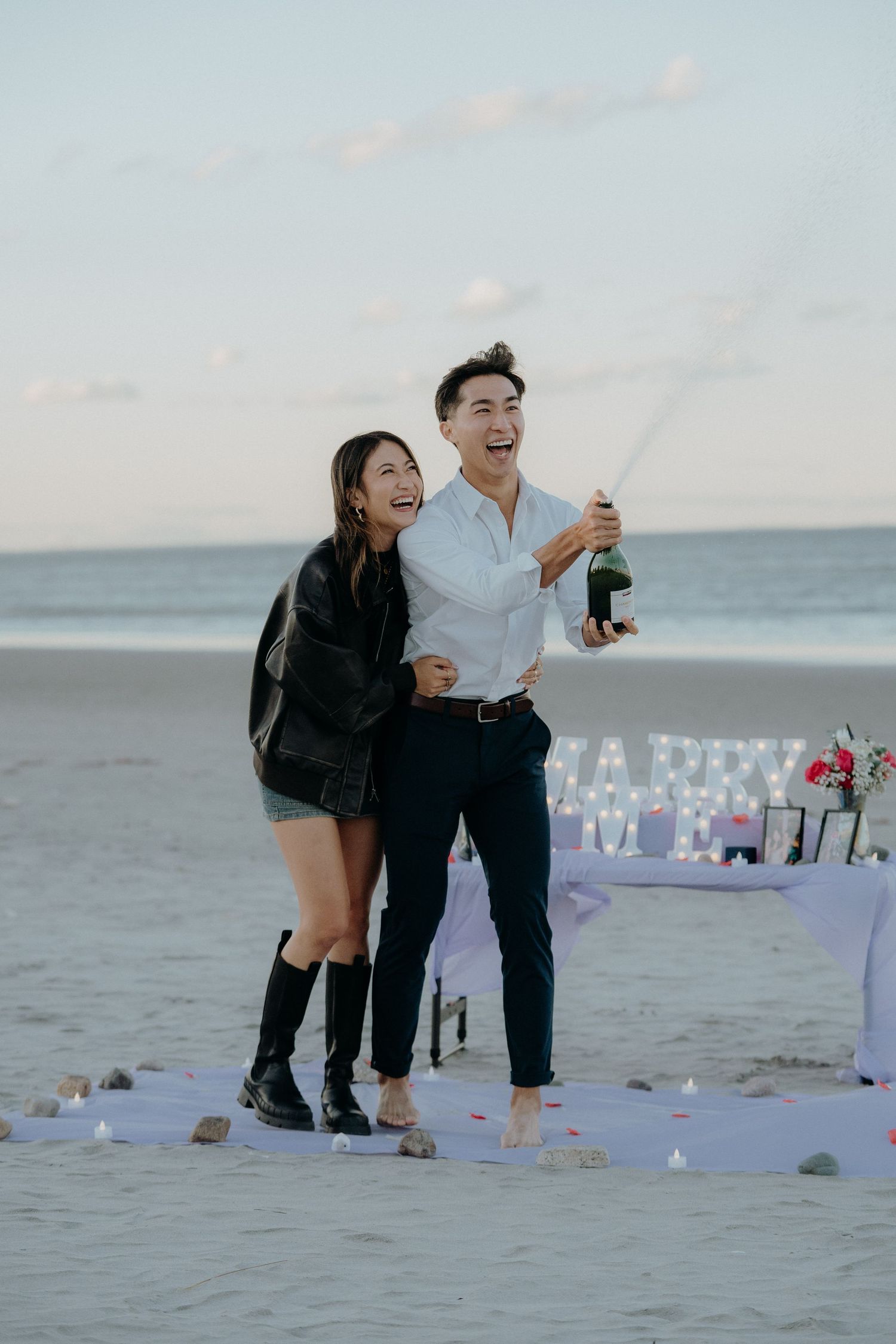 Eric and Emily popping champagne