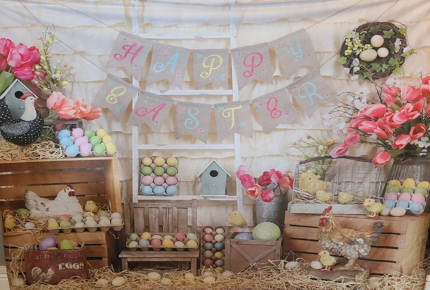 Rustic Easter backdrop with wooden crates, pink flowers, and decorative eggs.
