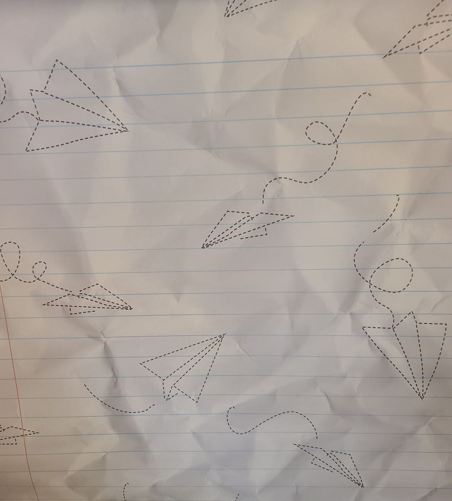 White lined paper with dotted paper airplane patterns and sketches.