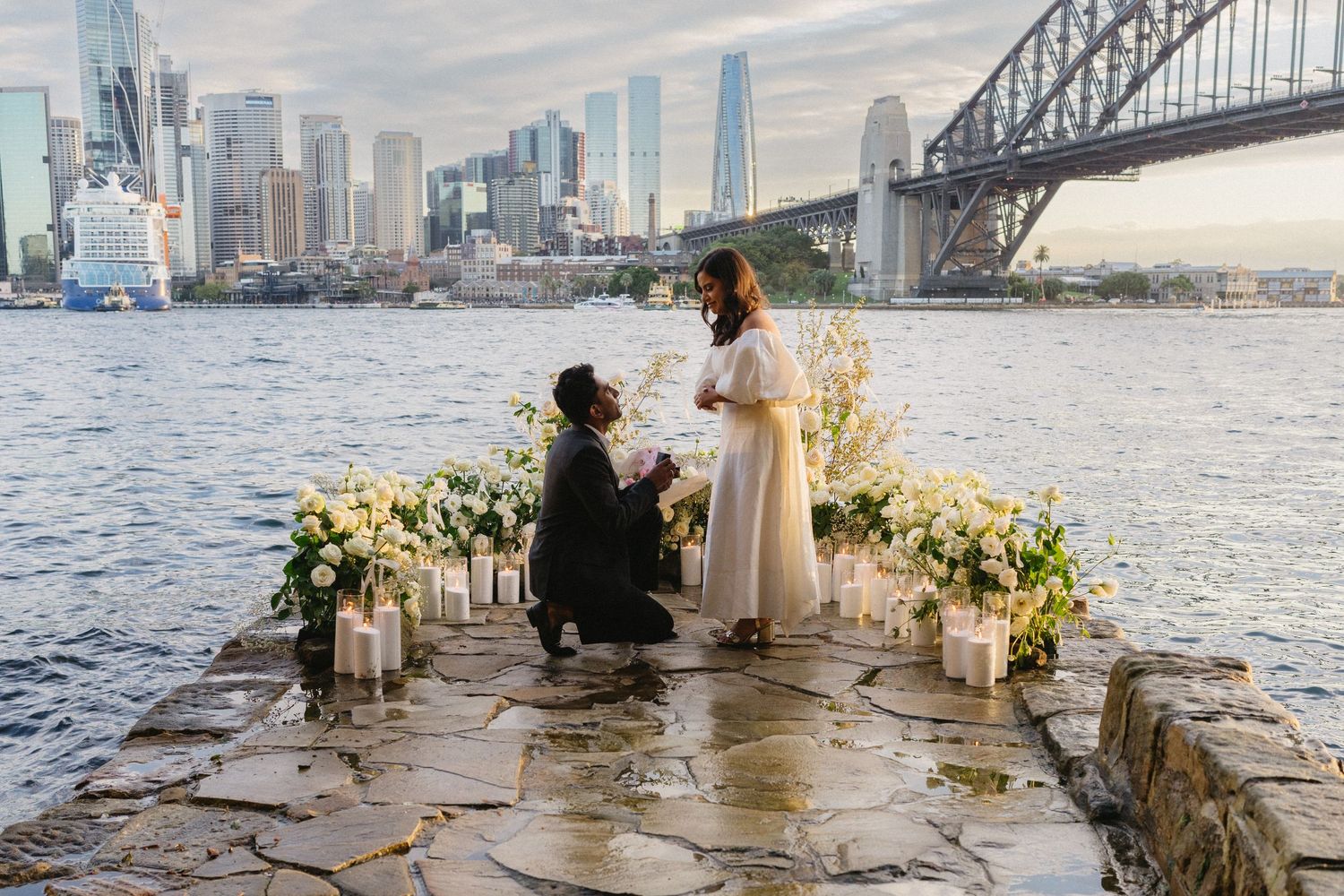 Scenic Sydney cityscape engagement gathering with city skyline and Harbour bridge in the background.