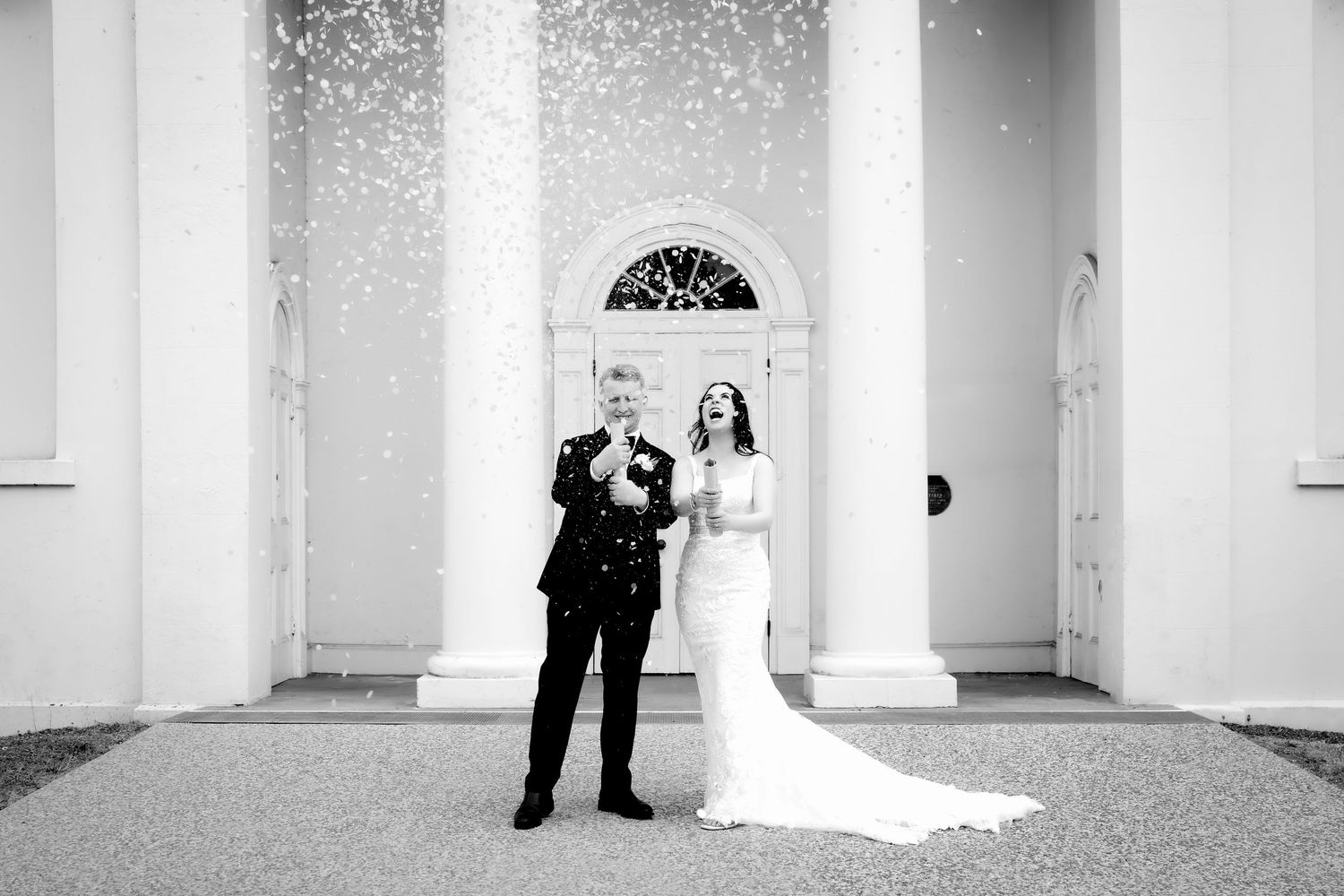 Intimate close-up portrait of wedding couple sharing tender moment against soft light.