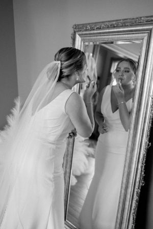 Elegant bridal portrait in black and white as final touches are made before the ceremony.