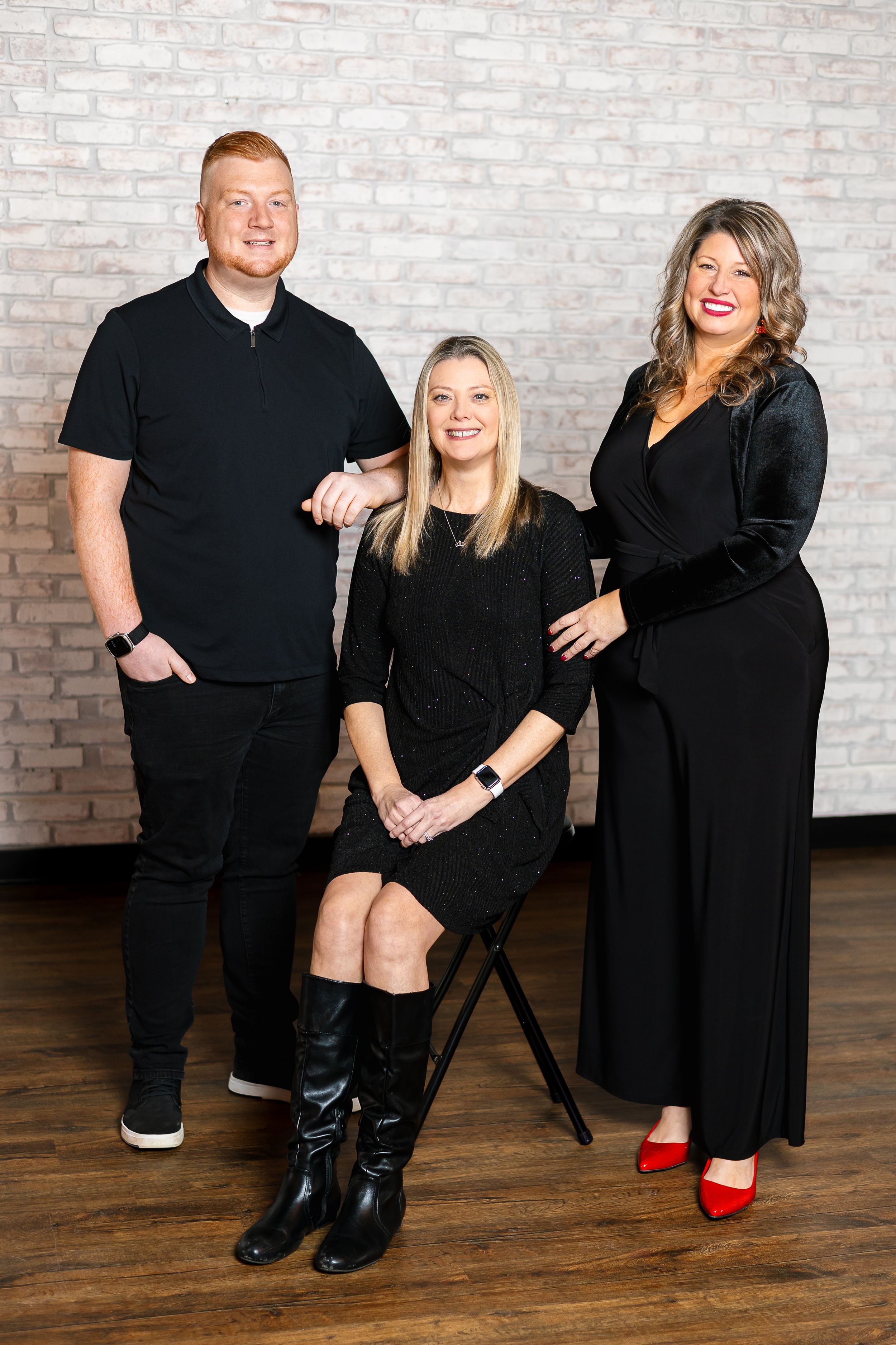 Four fashion studio photos show people wearing black outfits posing against a brick wall while displaying stylish boots.
