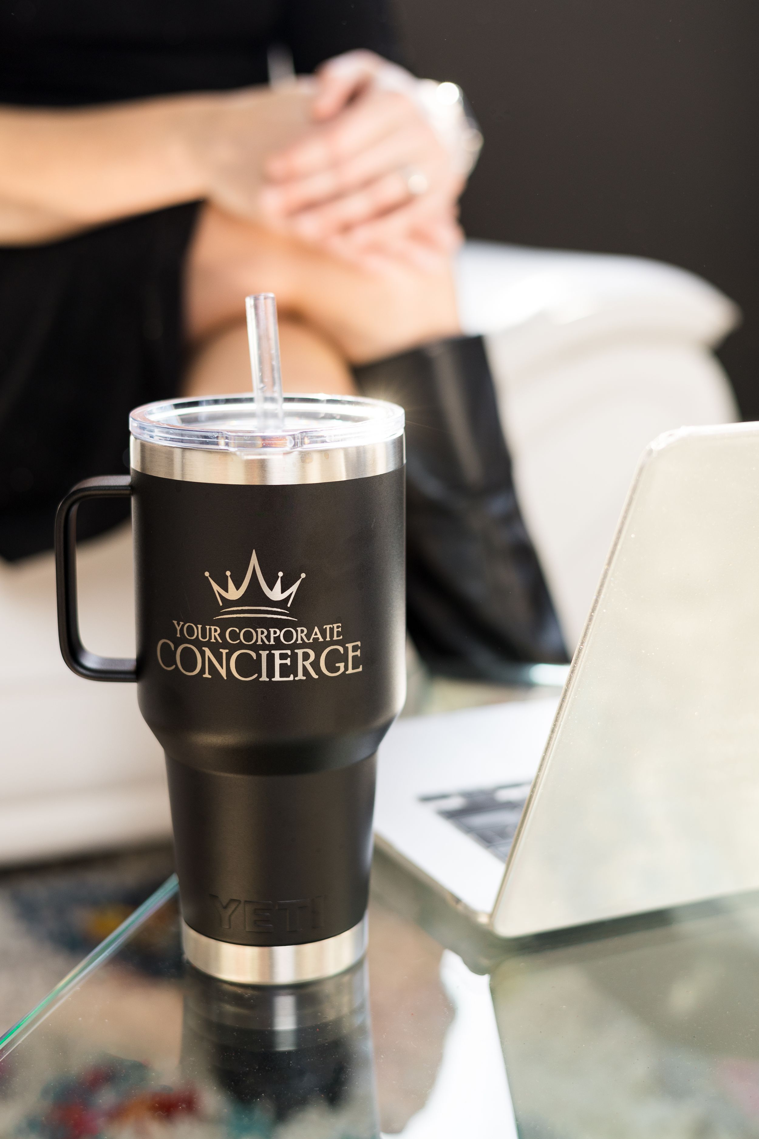 A series of black insulated travel mugs with crown logos and 'Concierge' branding displayed on a white surface.