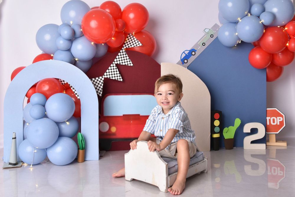 Red and blue balloon display with traffic signs and road themed party decorations.