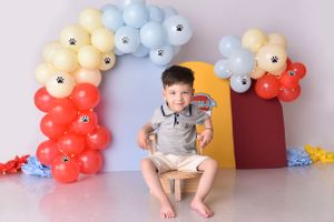 Rainbow ombre balloon arch with colorful panels creates cheerful birthday photo backdrop.