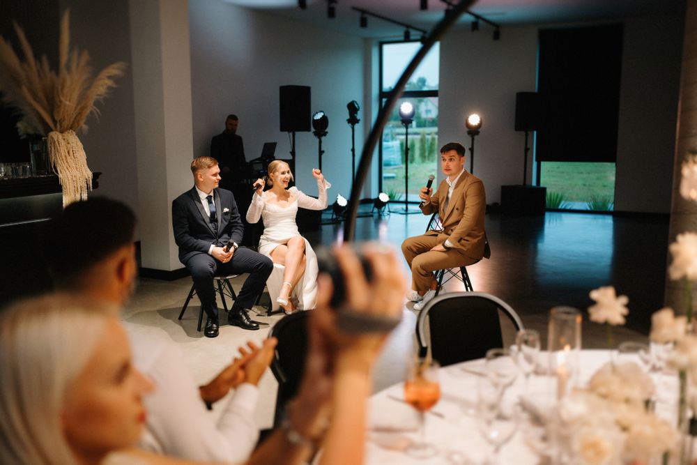 Elegant wedding reception with mood lighting and formal table settings.