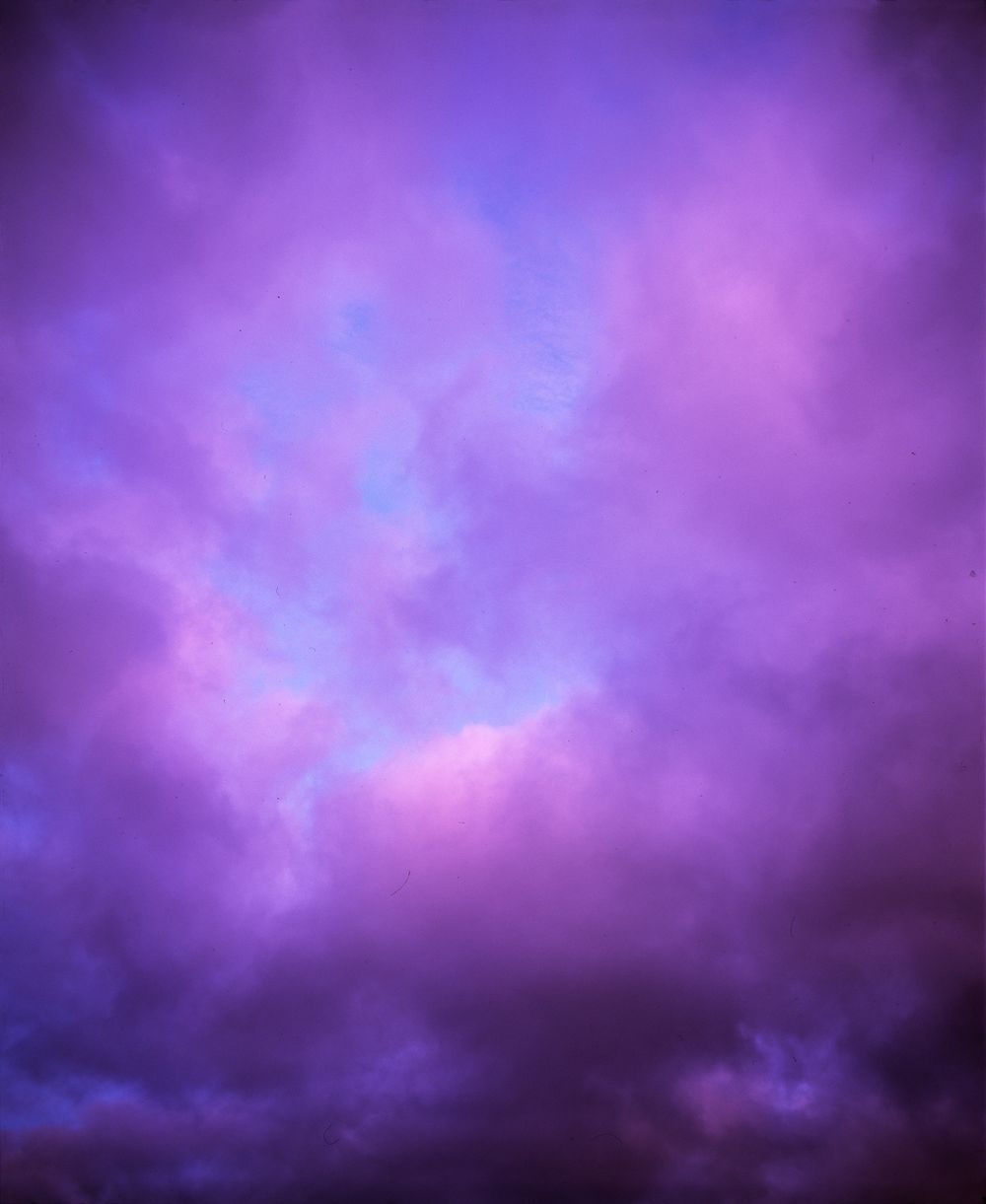 Dramatic purple and blue storm clouds create a mystical twilight sky.