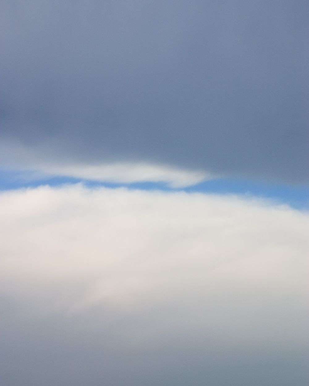 Soft white clouds against a pale blue sky create a tranquil atmospheric backdrop.