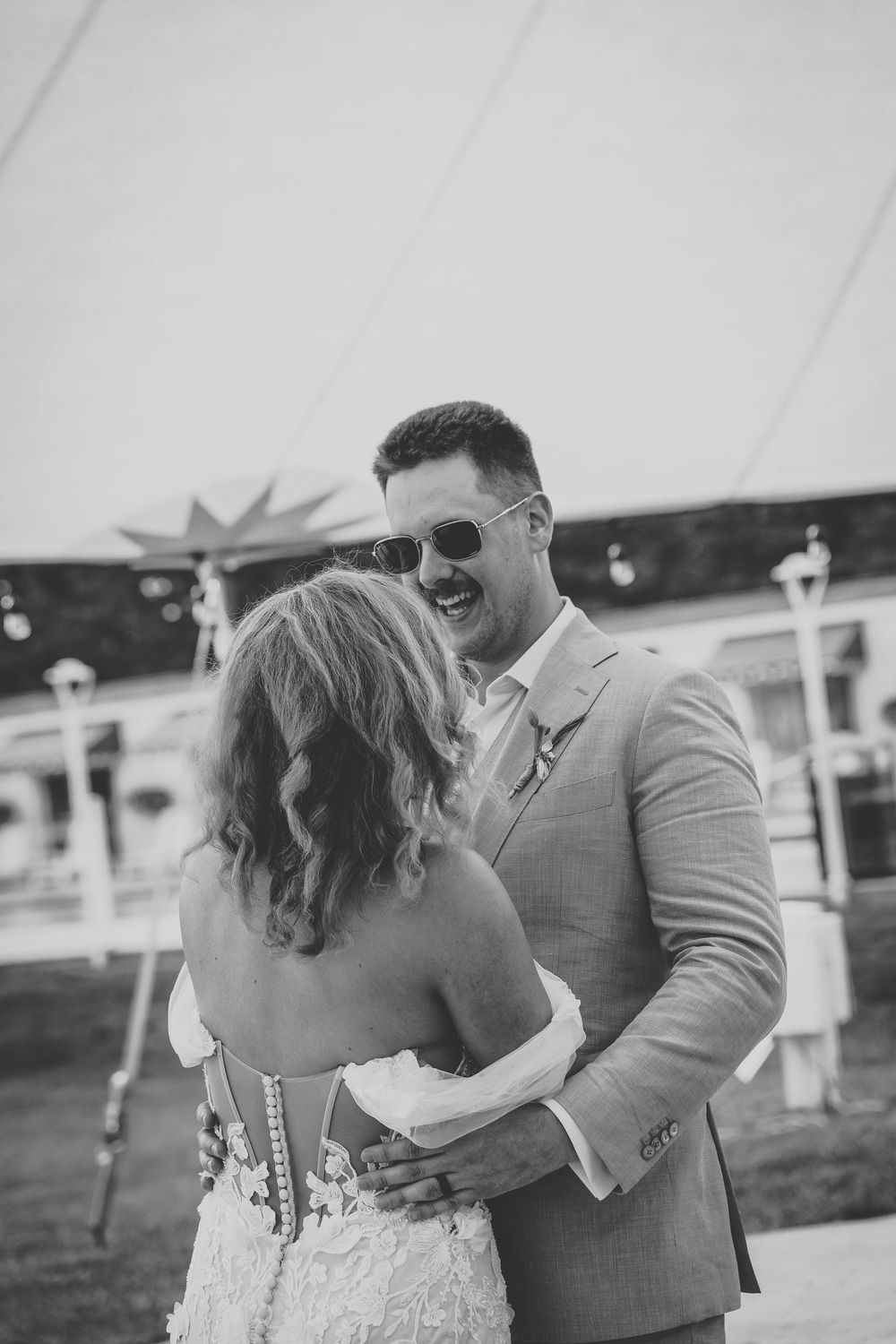 A romantic black and white photo series shows a couple sharing tender moments and kisses outdoors.