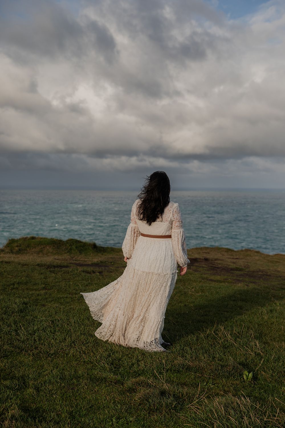 bride on Cliffs of Moher during sunrise elopement session