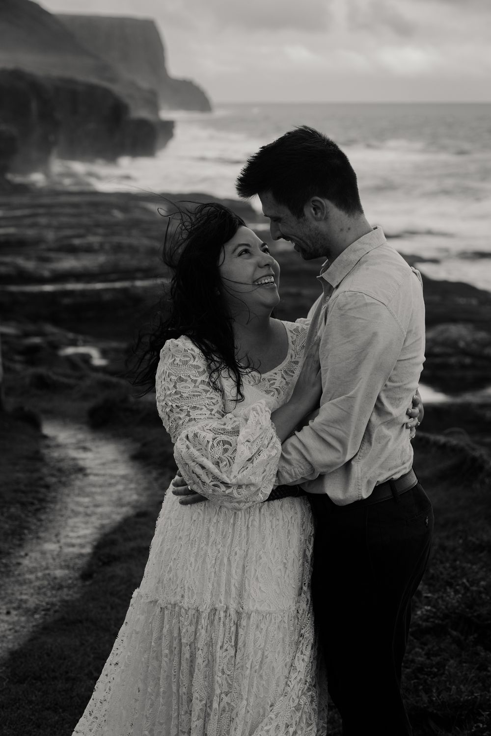 Couple laughing together during sunrise elopement at Cliffs of Moher