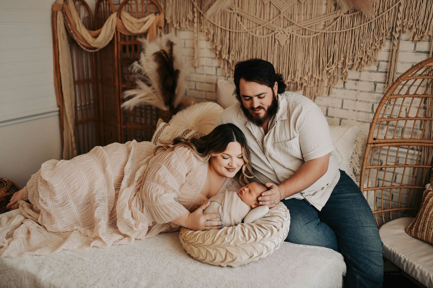 Mom and dad sharing a quiet moment with their newborn