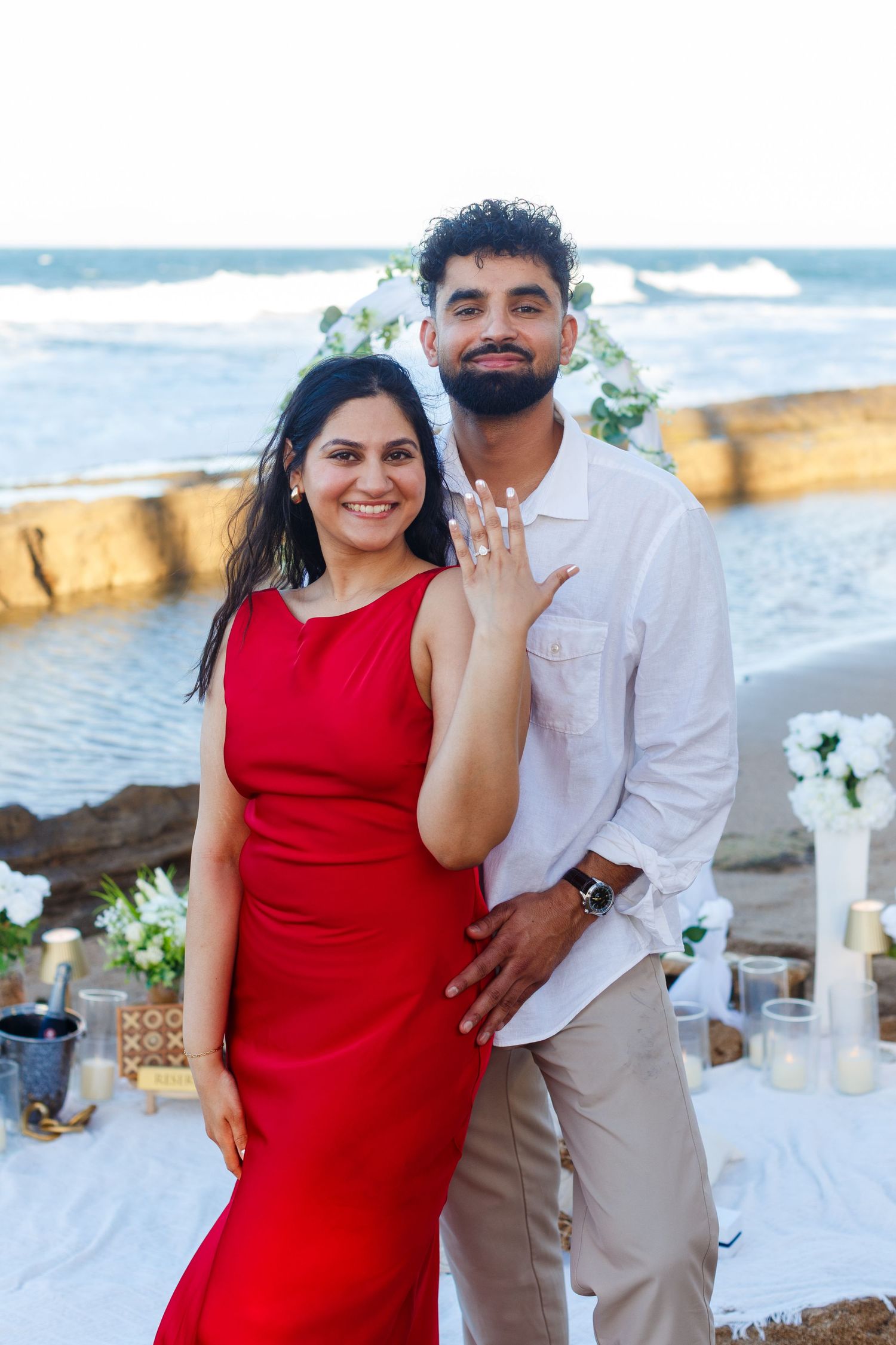 Couples portrait. Proposal and engagement session. Man and woman on the beach. Showing ring. Kikita Surf Beach, Dorado, Puerto Rico.