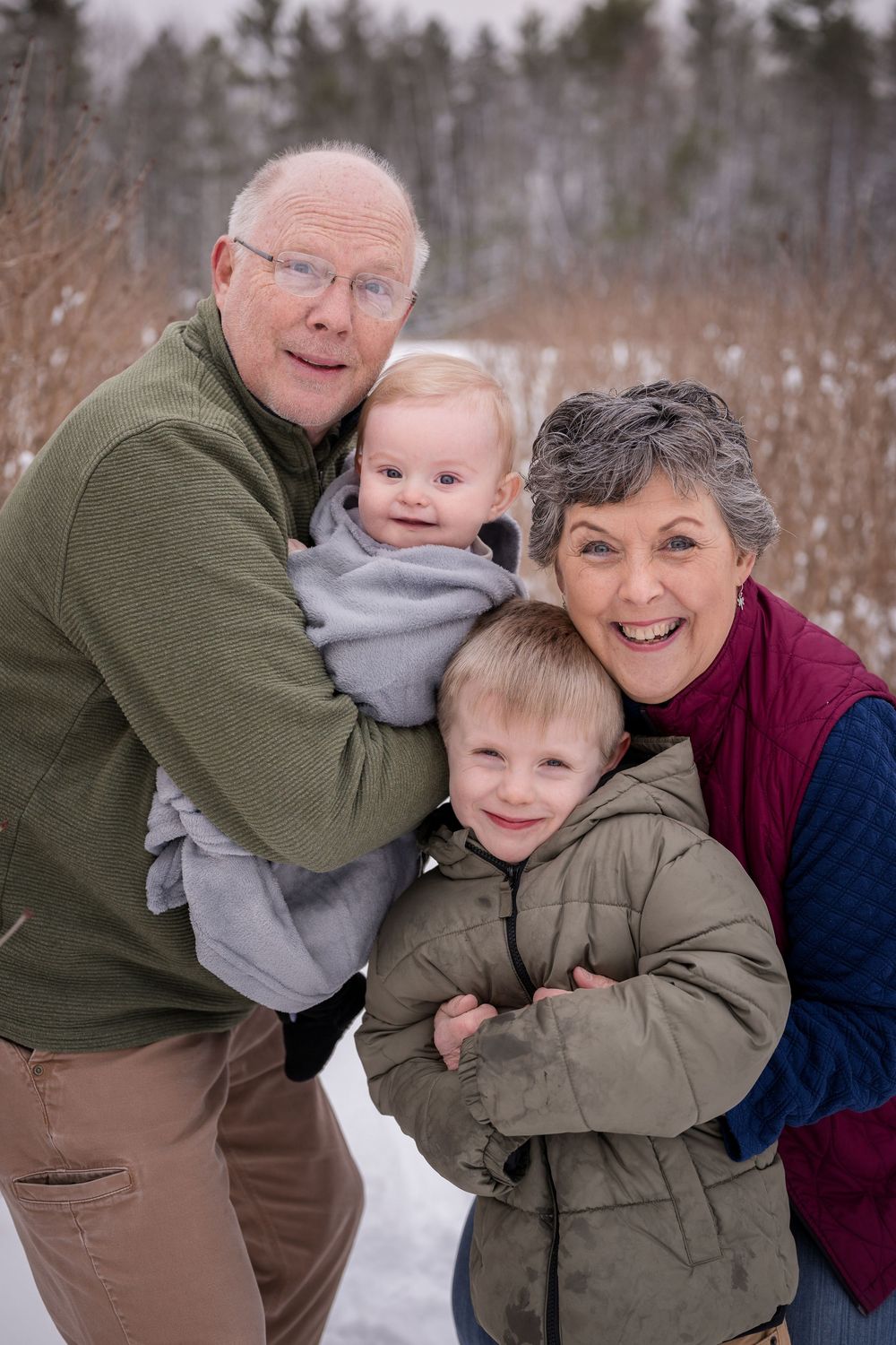 Candid moments of family members embracing and laughing together in a snowy setting.