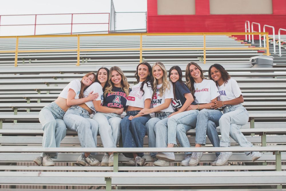 Students sitting together on outdoor bleachers during a sunny day at school.