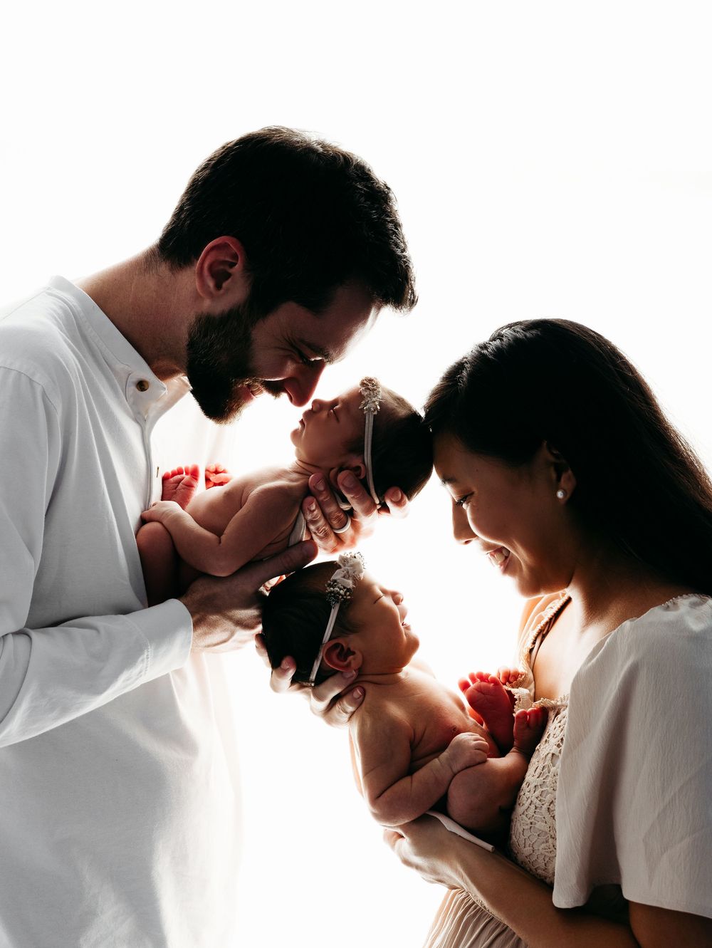 Romantic silhouette sequence of a couple in white against bright background.