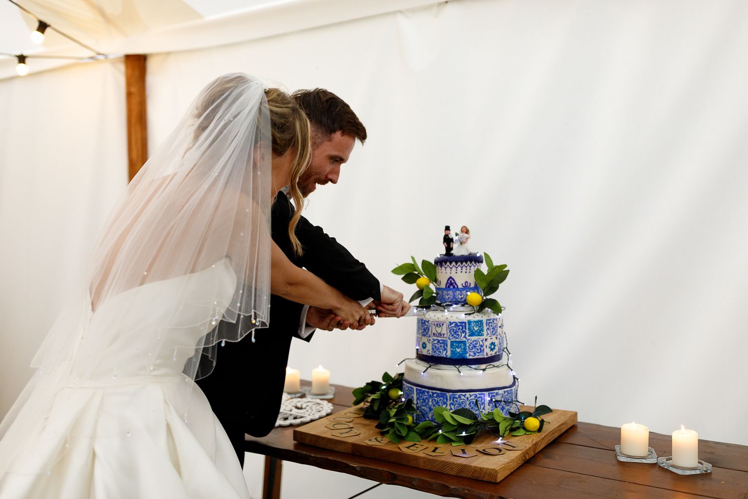 A collage of wedding photos showing cake cutting, table decorations and veil details at an elegant reception celebration.