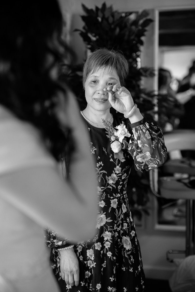 A series of black and white photos showing someone in a floral dress making playful expressions and gestures.