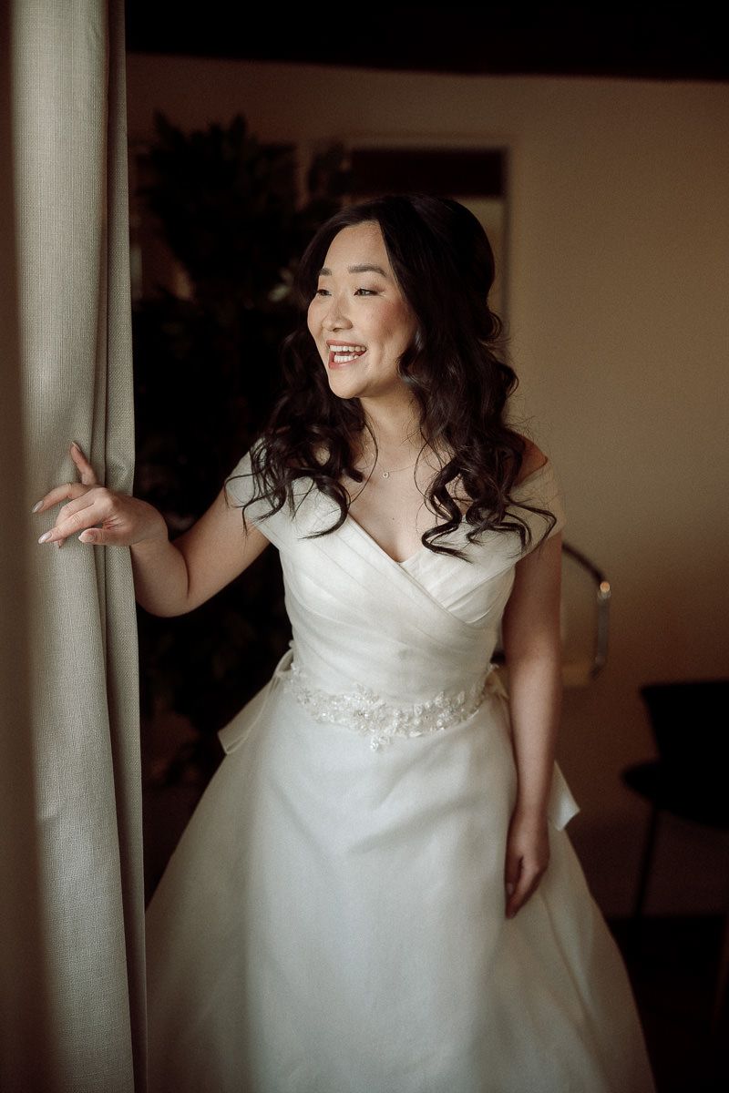 A series of photos showing a bride in a white wedding dress posing playfully against white pillars.