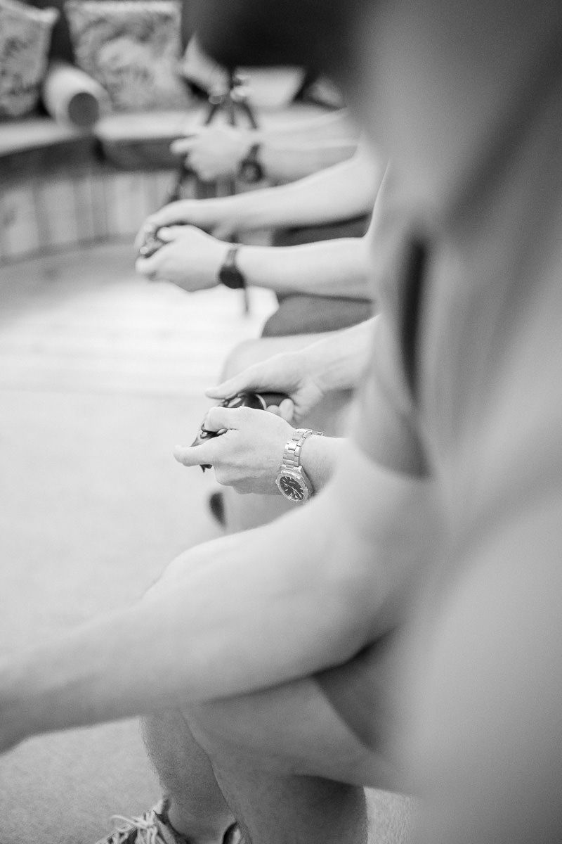 Close-up black and white shot of hands writing on paper with a pen in a soft focus style.