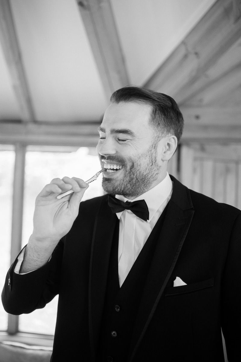 Black and white photo sequence showing a man in formal attire laughing progressively harder from left to right.