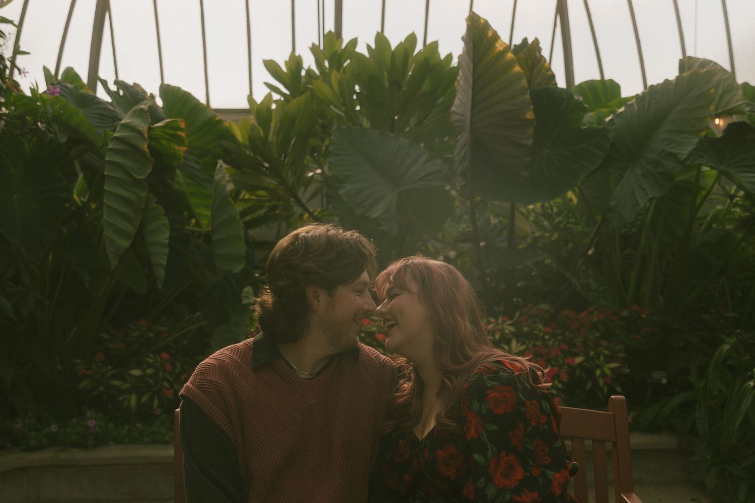 An engaged couple laughing together at the Belle Isle Conservatory in Detroit, Michigan taken by Richelle Healy Photo