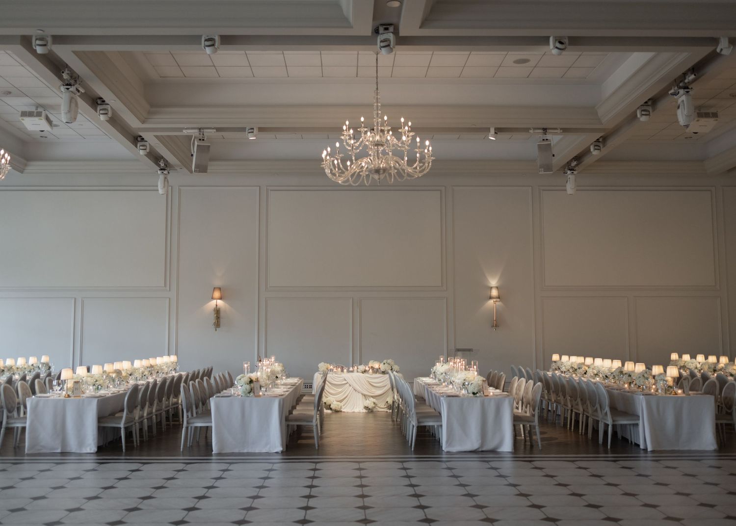 Elegant white ballroom with crystal chandeliers and checkered marble floors features multiple viewing angles.