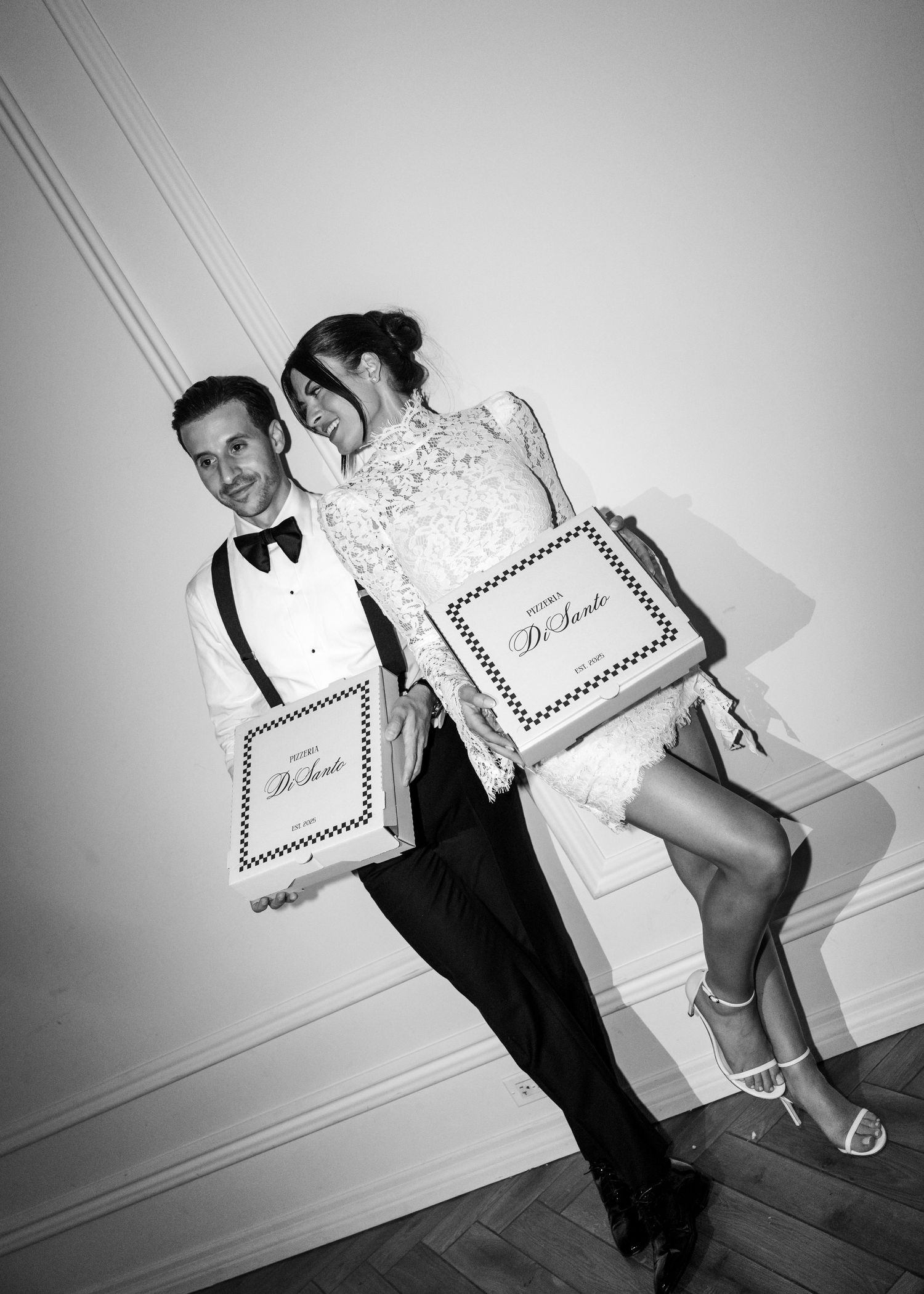 A series of black and white photos showing a couple in formal attire playfully posing with a diploma against a white wall.
