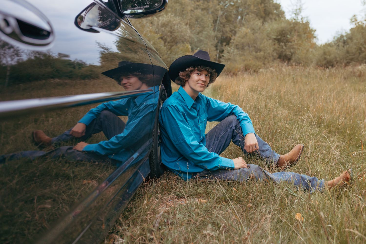 Senior sitting by their Monte Carlo during a relaxed senior session in Wausau, Wisconsin