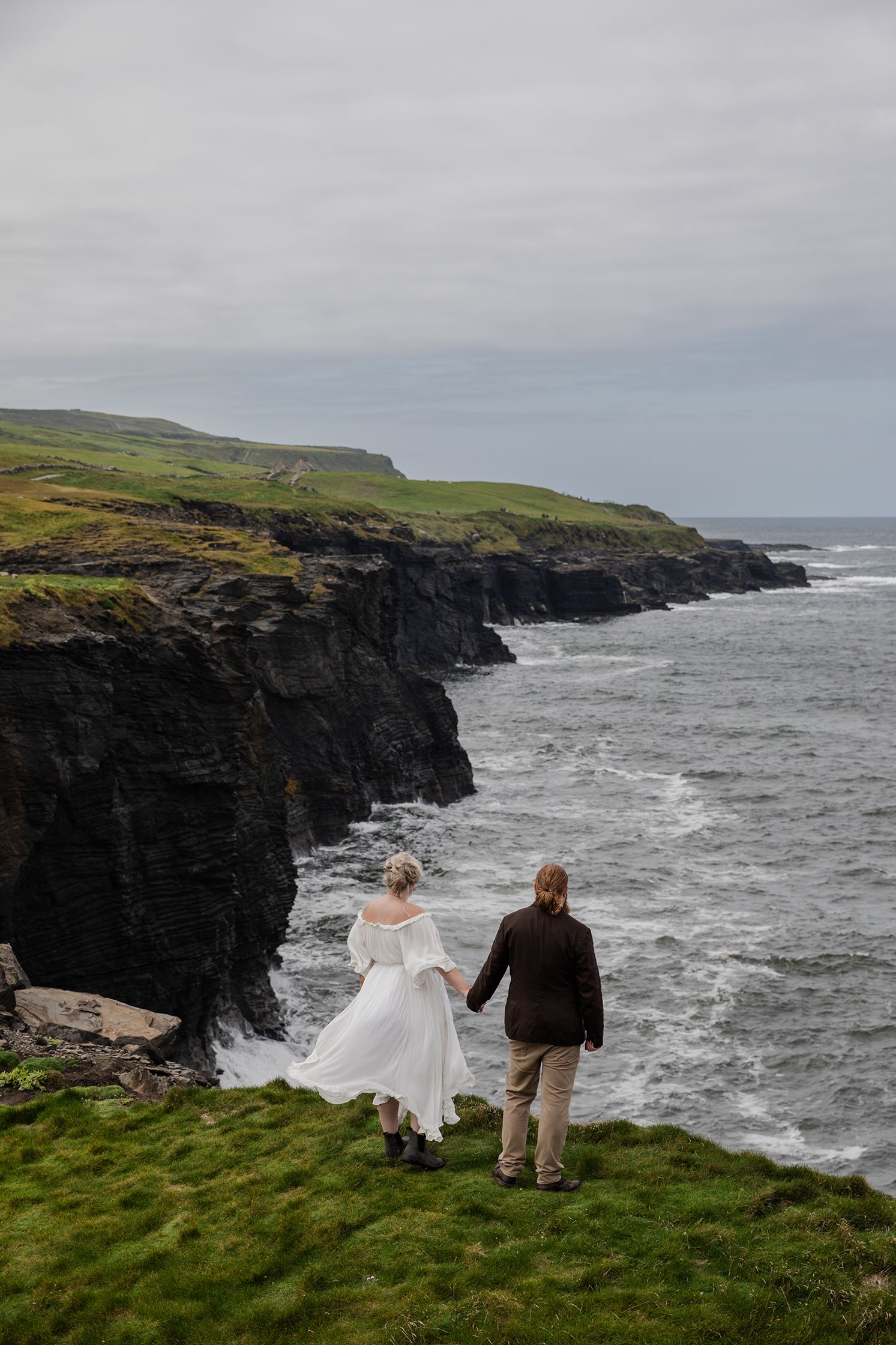 Bride reacting emotionally during vow exchange at cliffside Ireland elopement ceremony