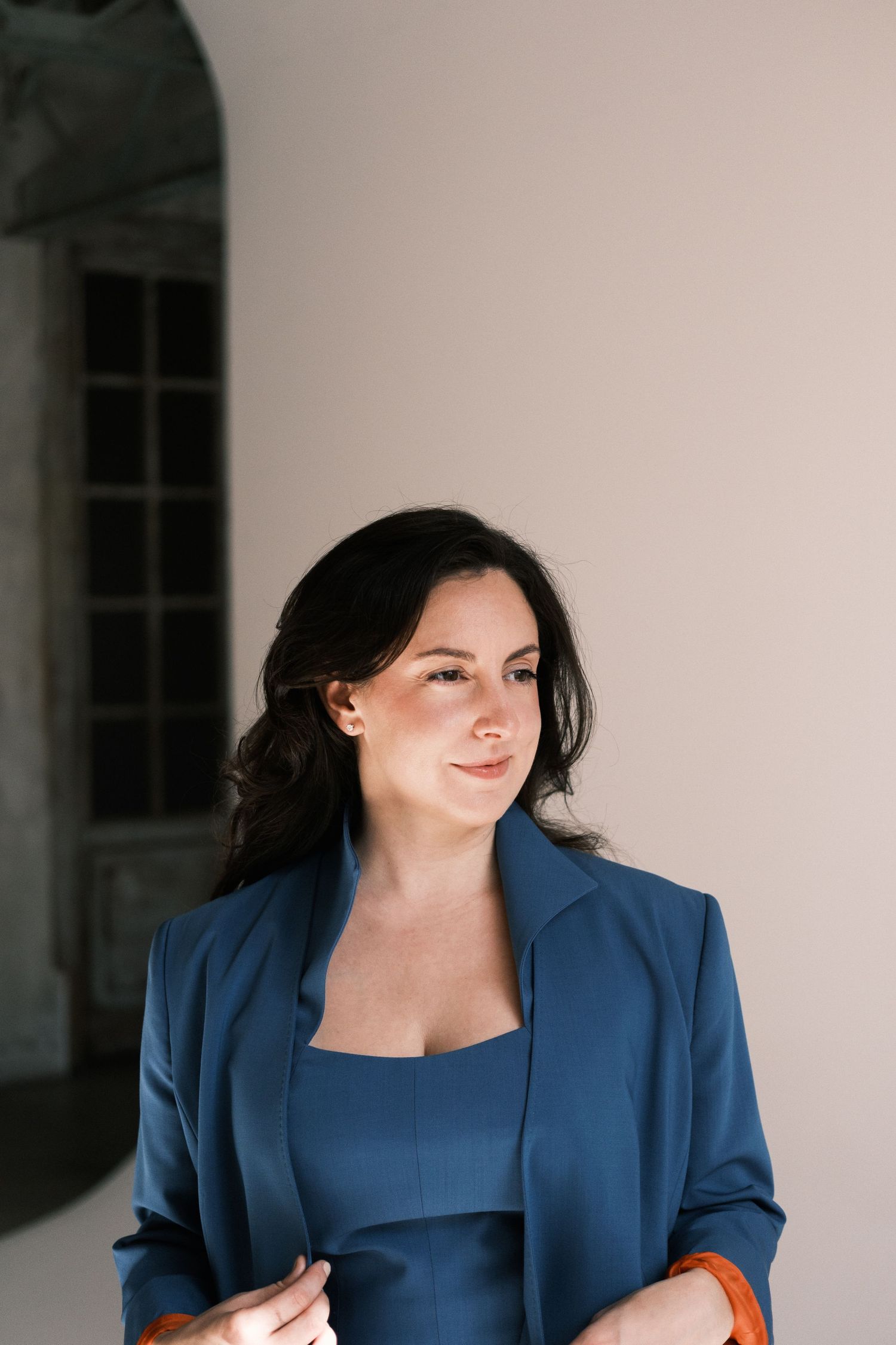 Professional portrait series showing a person in a navy blue blazer and top against a white background, smiling warmly.