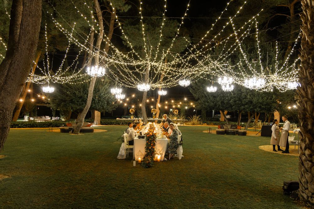 Wedding party sit down to banquet in garden of Italian villa