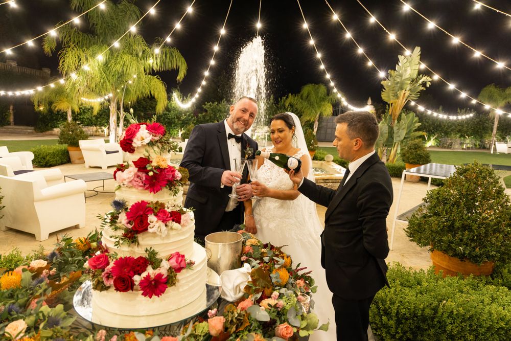 Bride and groom cut lavish cake at destination wedding in Italy