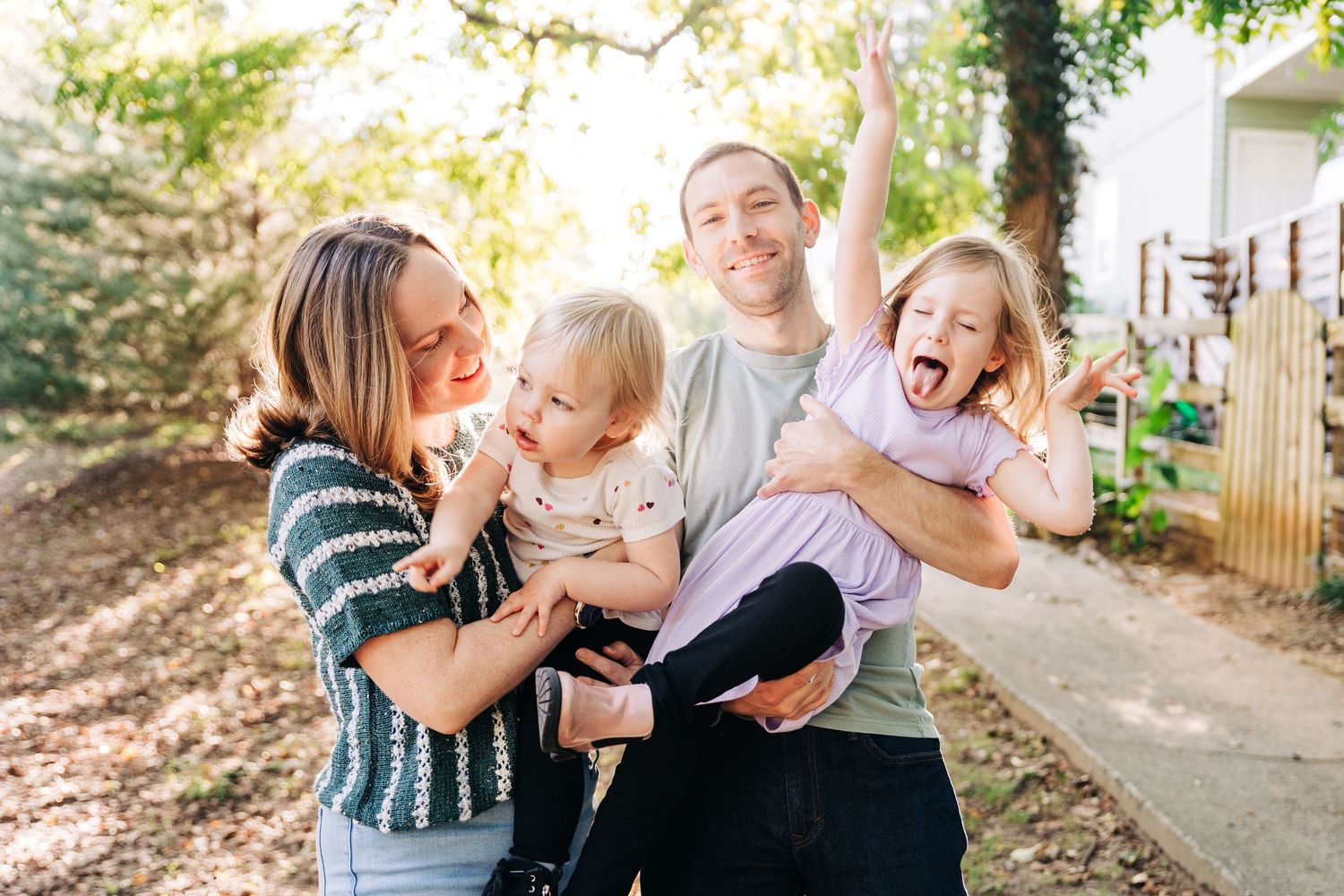A joyful family plays and laughs together at their favorite Charlotte area park.