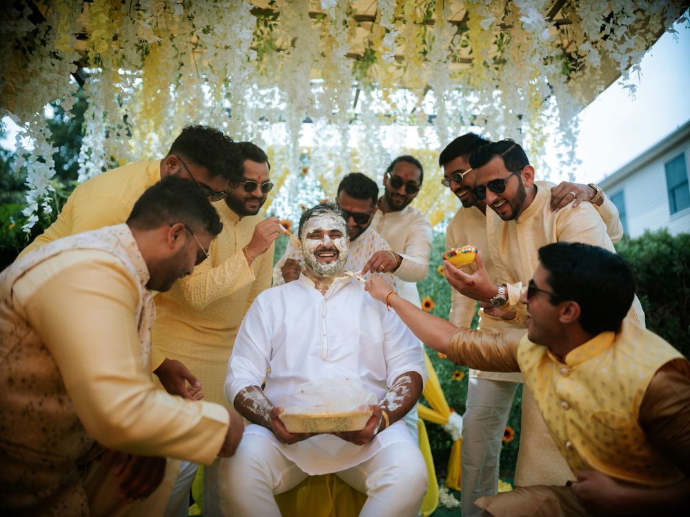 A group of people in traditional Indian attire perform a ceremonial ritual during a wedding celebration.