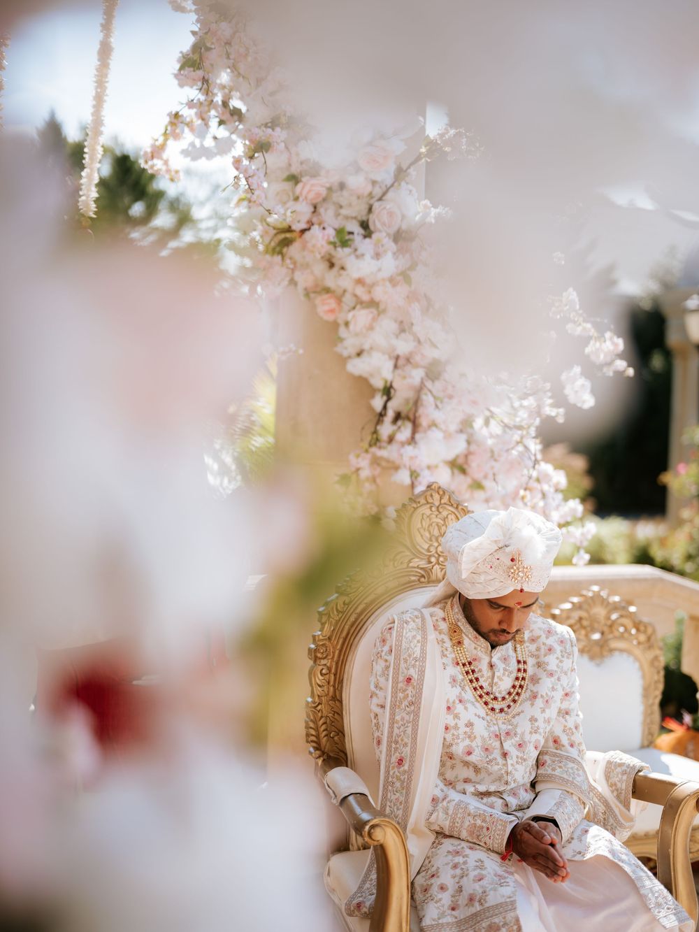 A traditional wedding ceremony setup with ornate decorations and cherry blossoms creating a romantic atmosphere.