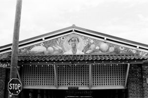 Vintage storefront with decorative architectural details and ornate trim above a brick building.