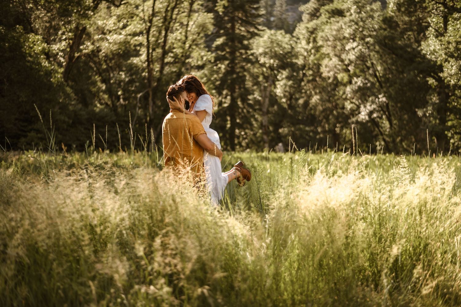 A romantic sunset photoshoot in a golden field with tall grass.